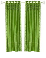 Forest green sari grommet top curtains hung at a window