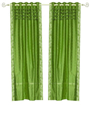 Forest green sari grommet top curtains hung at a window