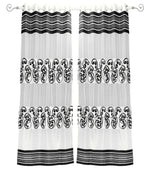Black sheer tissue ring top curtains hung at a window