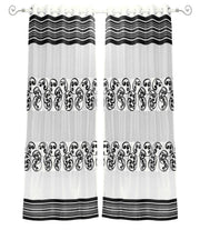 Black sheer tissue ring top curtains hung at a window