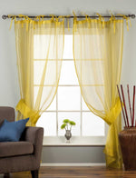 Sheer tissue tie top curtains hung at a window