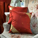 Rust sari cushion covers arranged on a sofa