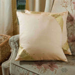 Gold sari cushion covers arranged on a sofa