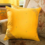 Yellow sari cushion covers arranged on a sofa
