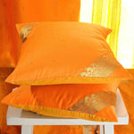 Pumpkin sari cushion covers arranged on a sofa