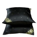 Black sari cushion covers arranged on a sofa