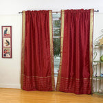 Maroon sari rod pocket curtains hung at a window