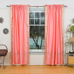 Pink sari rod pocket curtains hung at a window