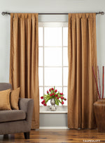 Taupe velvet tab top curtains hung at a window