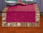 Maroon silk table runner running down a dining table