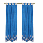 Turquoise sari tab top curtains hung at a window