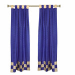 Blue sari tab top curtains hung at a window