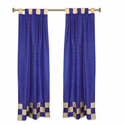 Blue sari tab top curtains hung at a window