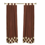 Brown sari tab top curtains hung at a window