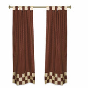 Brown sari tab top curtains hung at a window