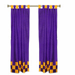 Purple sari tab top curtains hung at a window