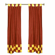 Yellow sari tab top curtains hung at a window