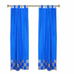 Coral sari tab top curtains hung at a window