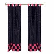 Black sari tab top curtains hung at a window