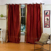 Rust sari tie top curtains hung at a window
