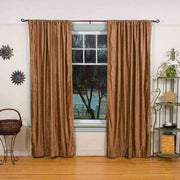 Taupe velvet rod pocket curtains hung at a window