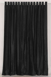 Black velvet tab top curtains hung at a window