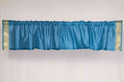 Turquoise sari valance mounted above a window