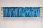 Turquoise sari valance mounted above a window