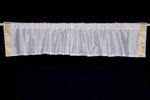 White sari valance mounted above a window