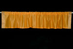 Mustard sari valance mounted above a window