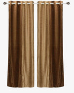 Taupe velvet ring top curtains hung at a window