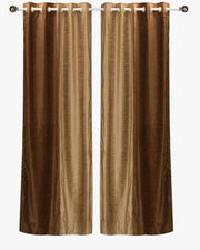 Taupe velvet ring top curtains hung at a window