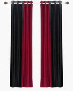 Burgundy velvet ring top curtains hung at a window