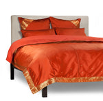 Rust sari duvet cover set made up on a bed