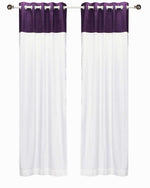 Purple velvet ring top curtains hung at a window