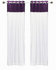 Purple velvet ring top curtains hung at a window
