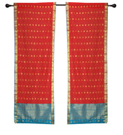 Red sari rod pocket curtains hung at a window