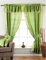Cream sari rod pocket curtains hung at a window