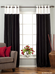 Black velvet ring top curtains hung at a window