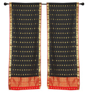 Black sari rod pocket curtains hung at a window