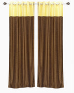 Yellow velvet ring top curtains hung at a window