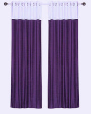 Purple velvet ring top curtains hung at a window