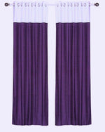 Purple velvet ring top curtains hung at a window