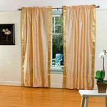Gold sari rod pocket curtains hung at a window