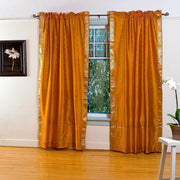 Mustard sari rod pocket curtains hung at a window
