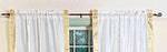 White sari rod pocket curtains hung at a window