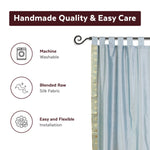 Gray sari tab top curtains hung at a window