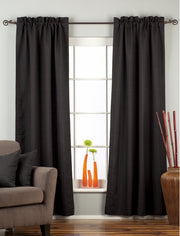 Black raw silk rod pocket curtains hung at a window