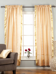 Misty rose sari rod pocket curtains hung at a window