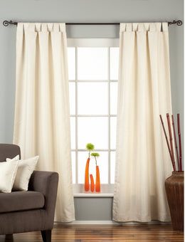 Cream raw silk tab top curtains hung at a window